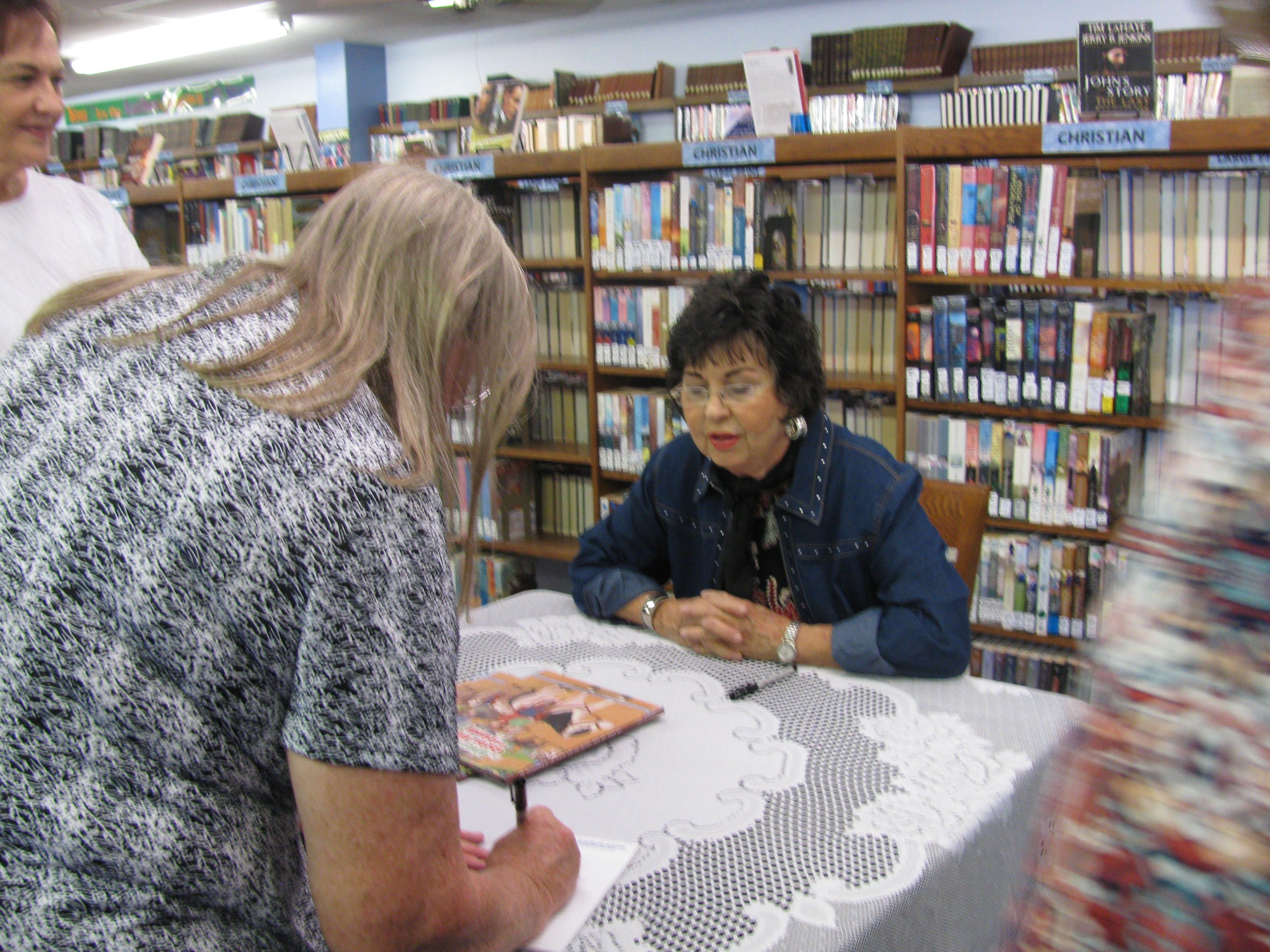 Janis Blackwell signing her book.JPG